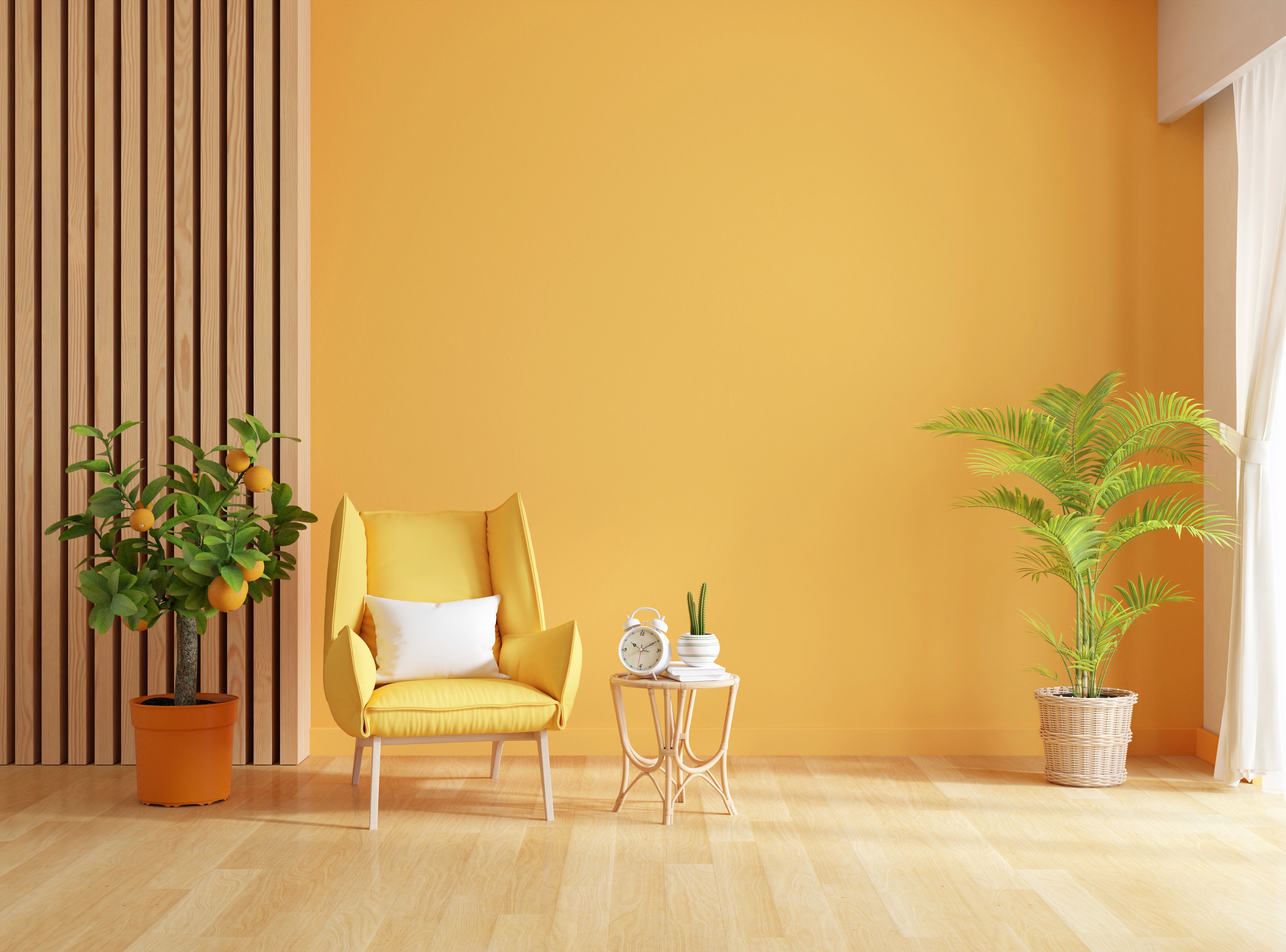 Living room with yellow armchair against a warm orange wall