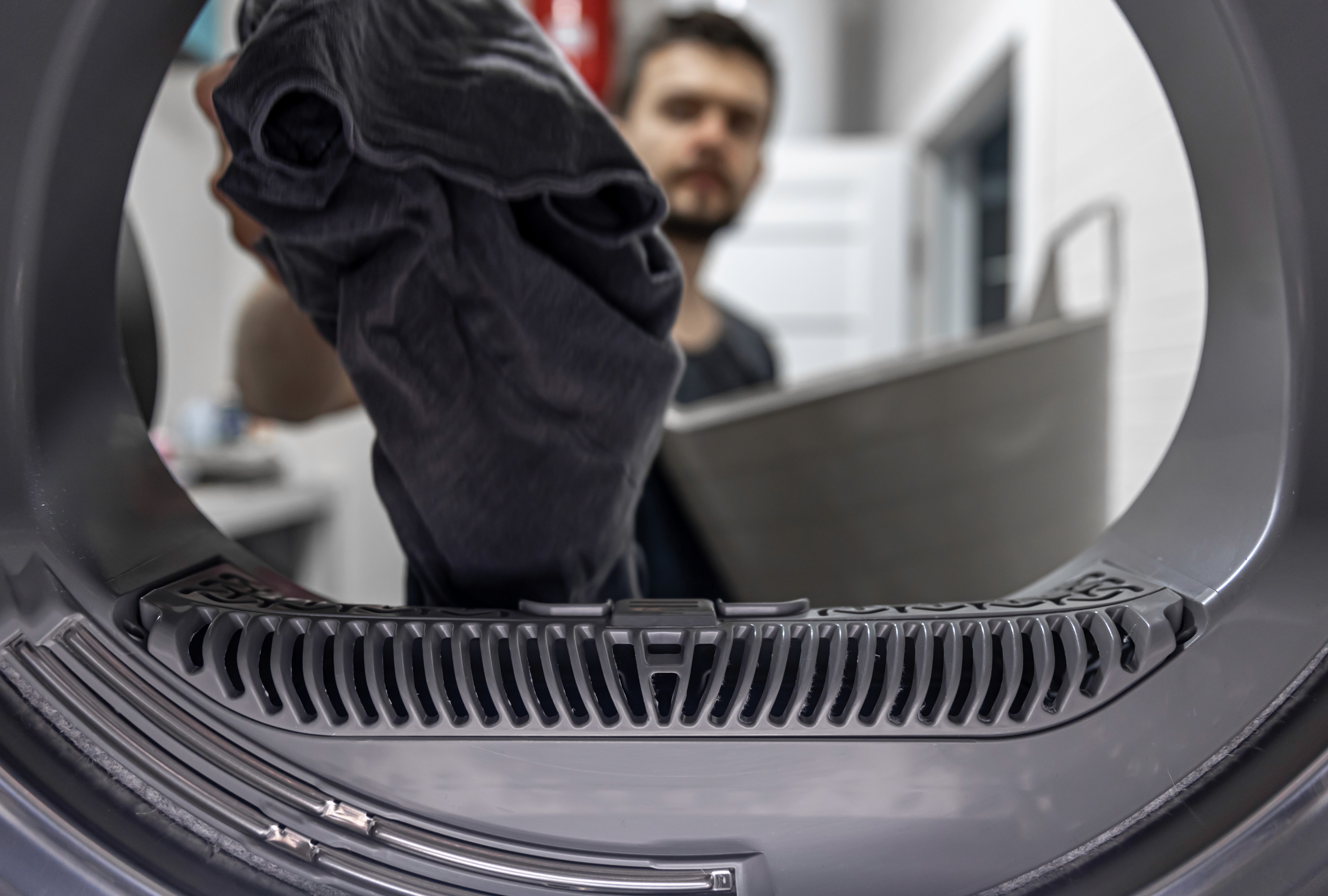 Close-up of a washing machine drum with clothing