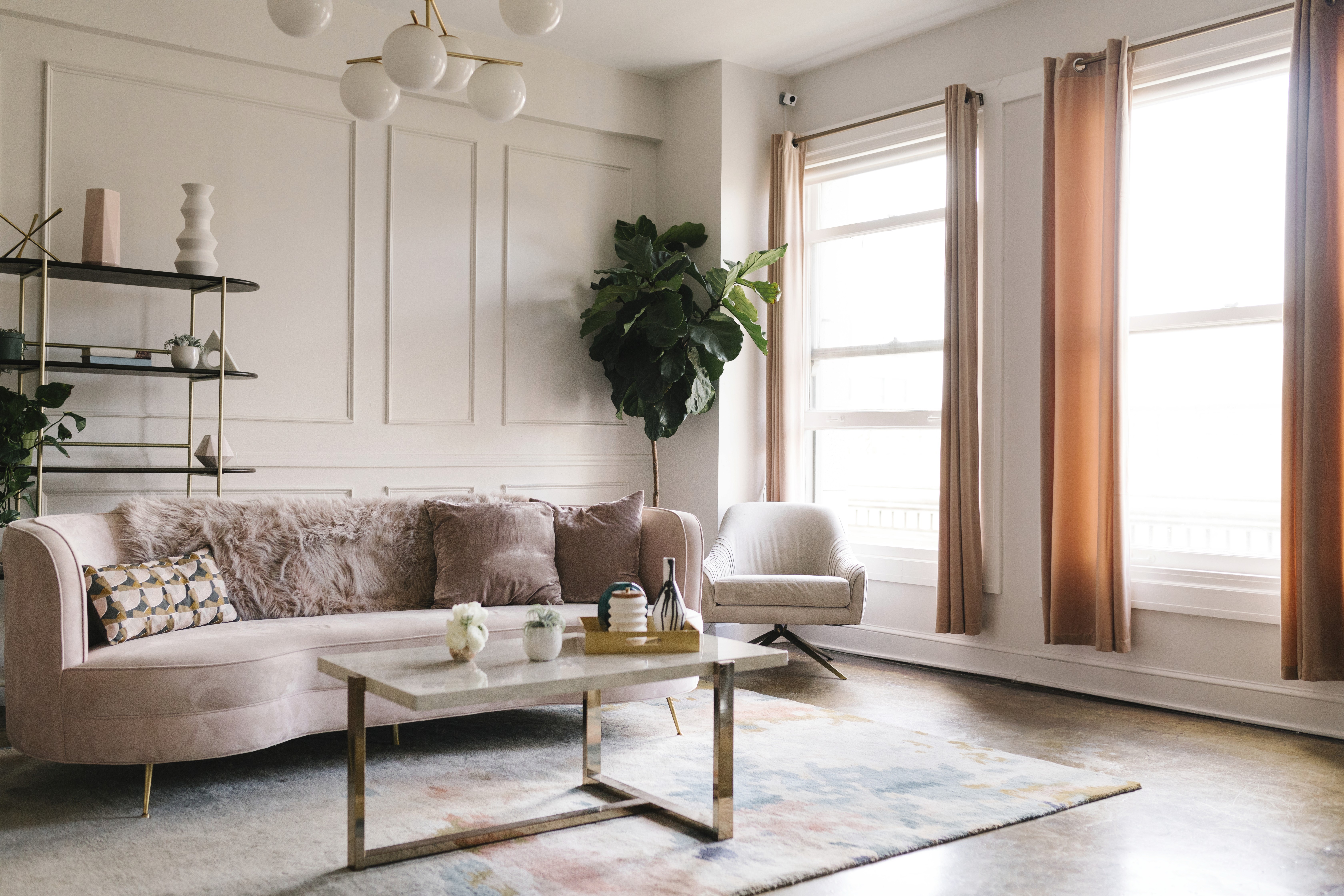 Living room with pink sofa and paneled accent wall