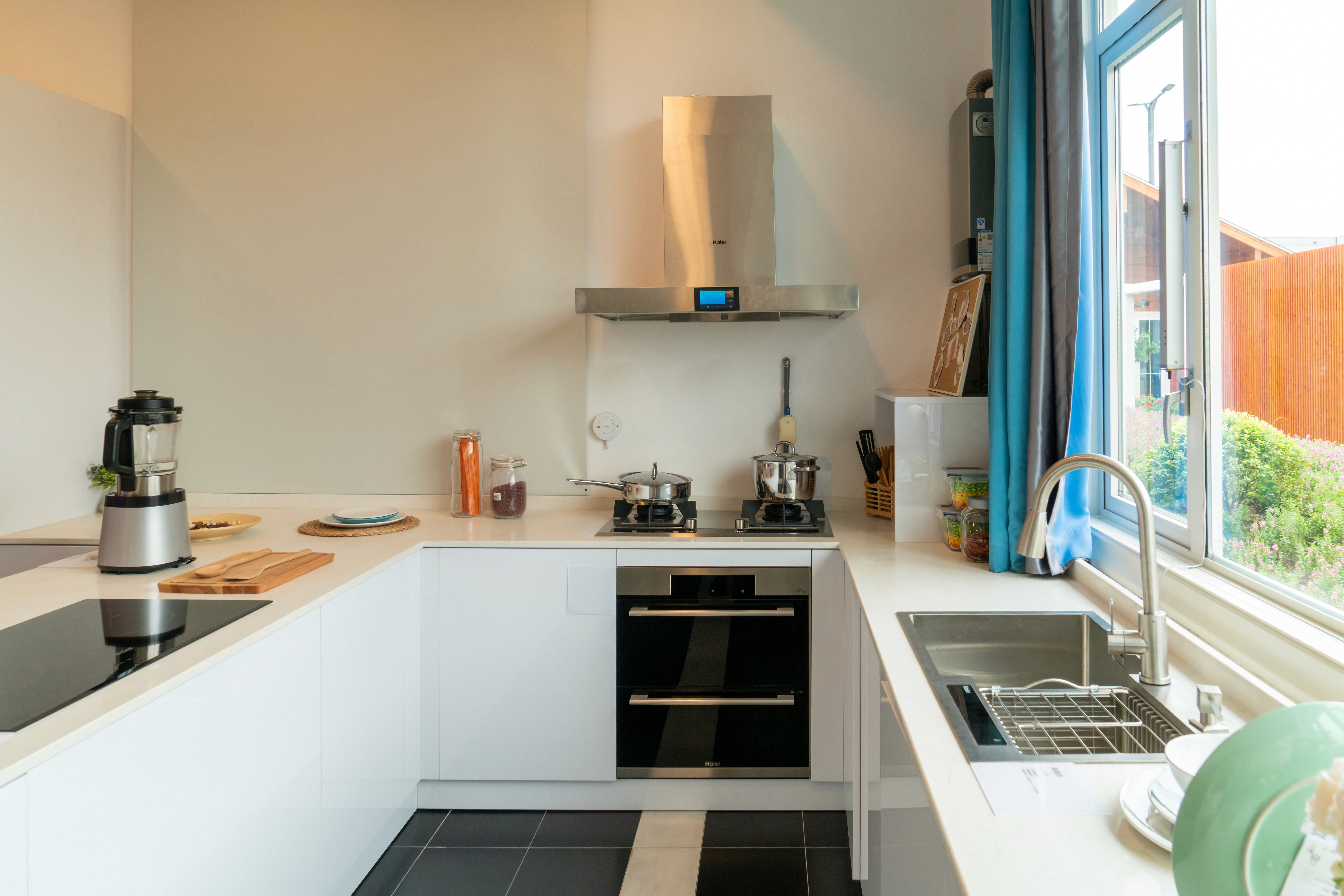 Bright white kitchen with wood countertops and stainless steel appliances