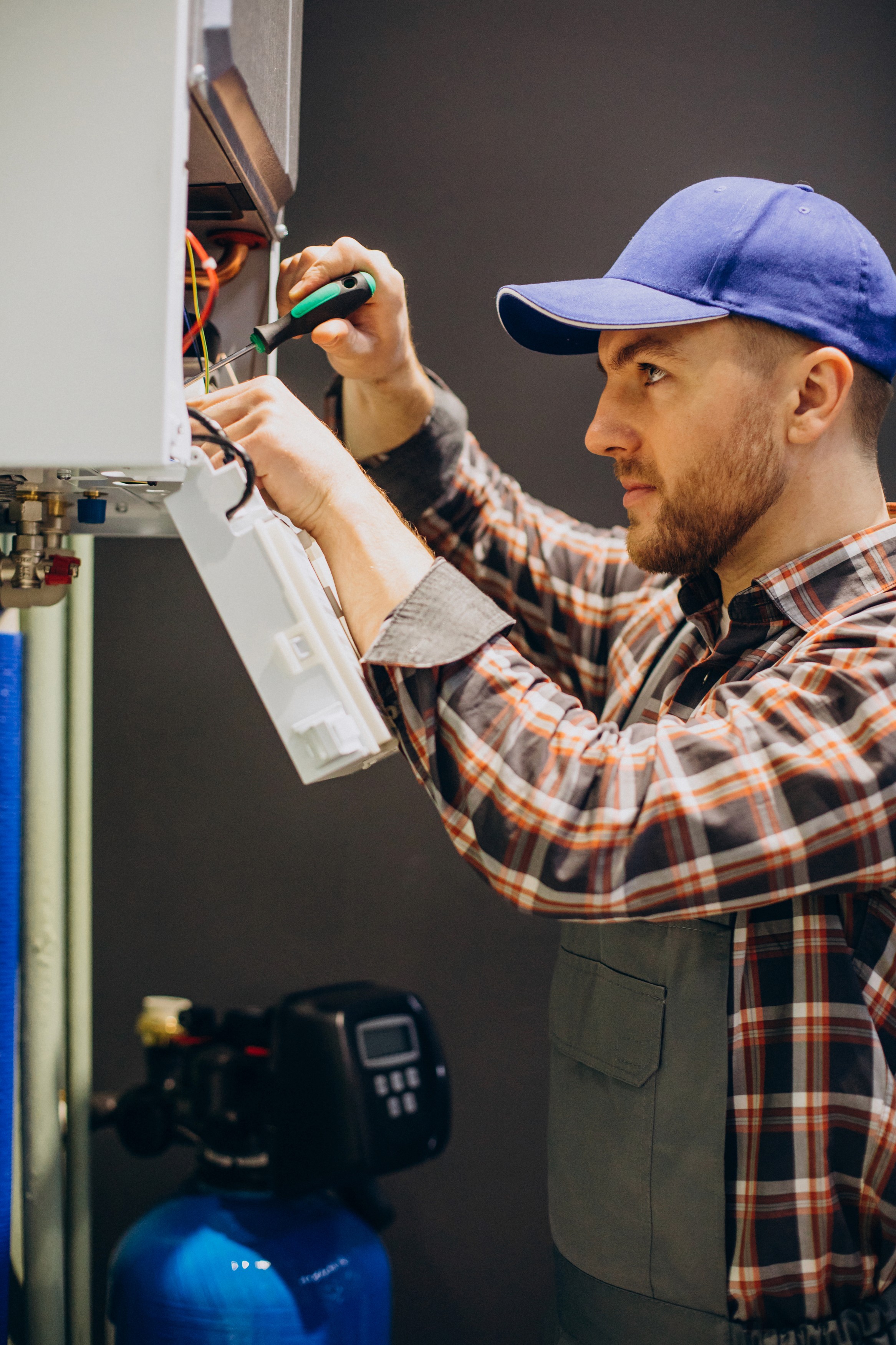 Technician working on HVAC wiring and controls