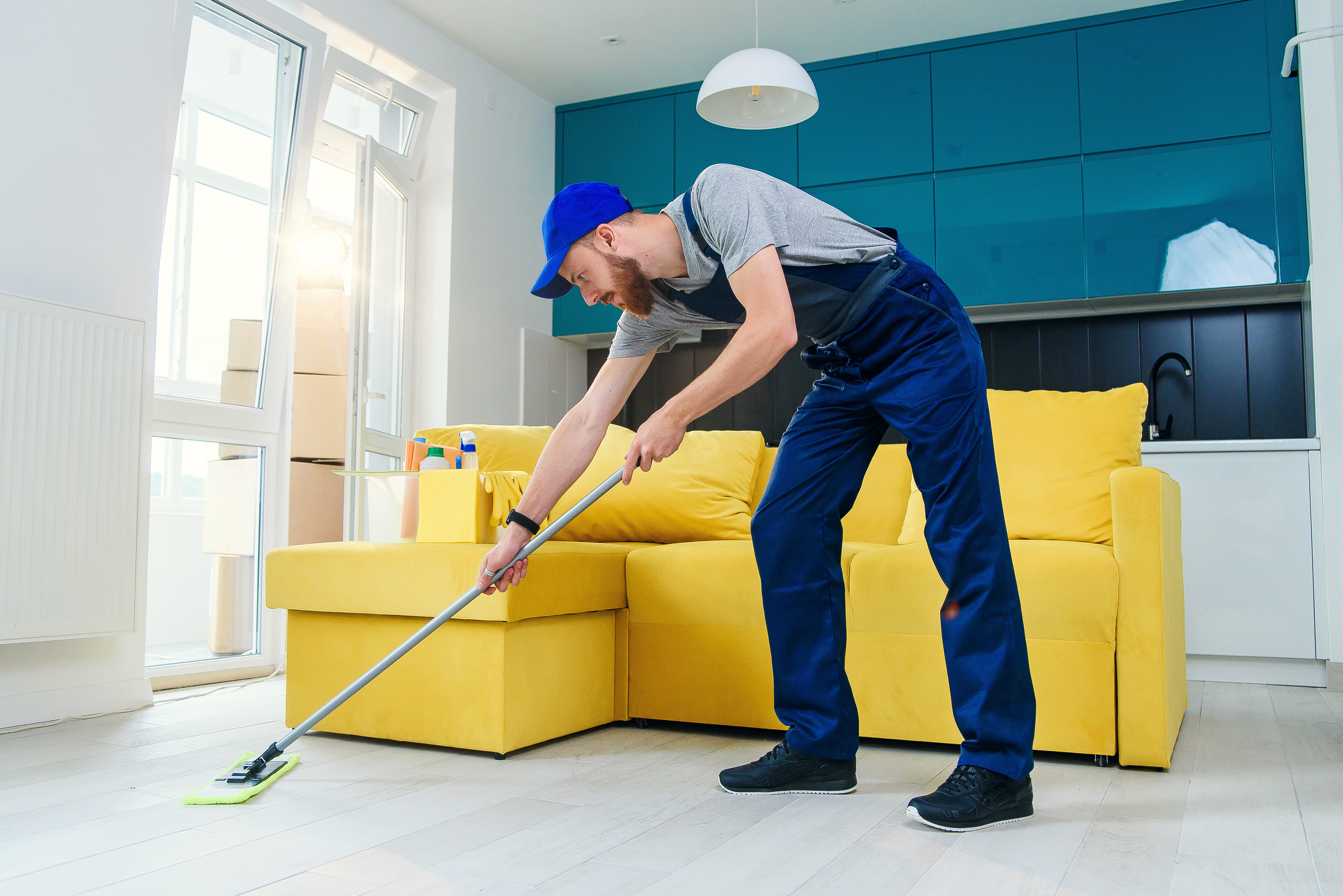Cleaner mopping the floor in a living room