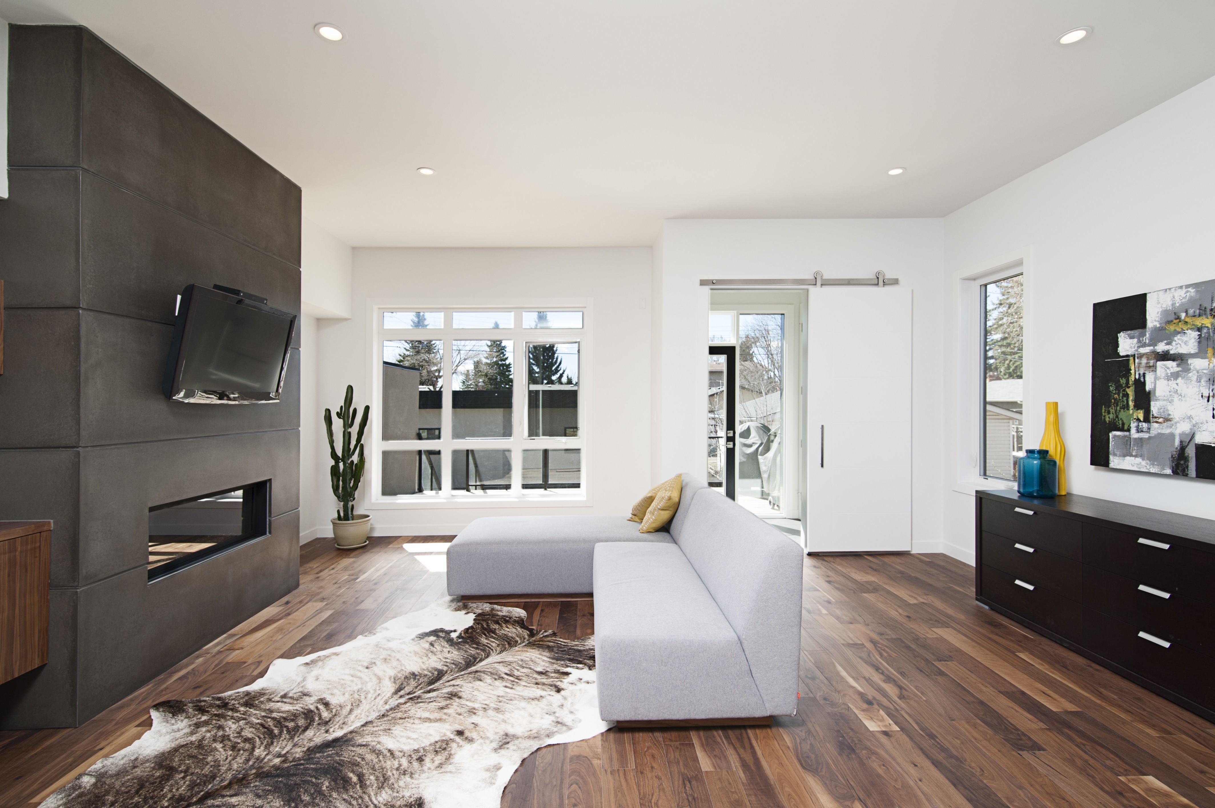 Modern living room with fireplace accent wall and gray sectional sofa